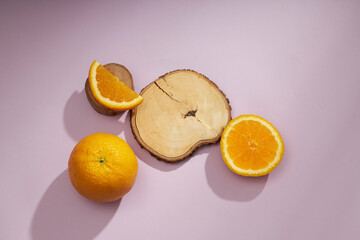 A front view of lemon decorated with transparent podium in green background 