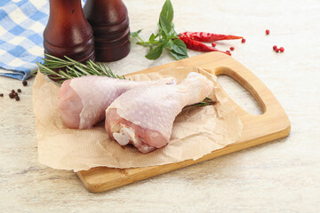 Raw chicken leg over board
