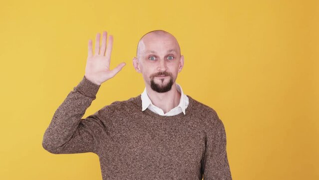 Goodbye leaving. Good luck. Boomerang motion. Comic bald man waving hand bye disappearing gif loop isolated on bright yellow copy space background.