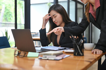 Dissatisfied boss scolding young employees, verbal warning about work failure