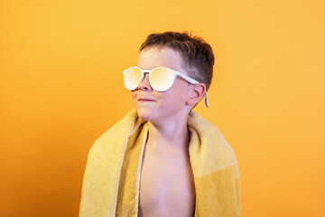Caucasian blonde boy in trendy sunglasses in yellow
