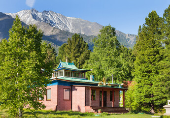 View of the Buddhist datsan Bodhidharma in the village of Arshan against the backdrop of the Eastern Sayan Mountains on a sunny day in June. Summer travel