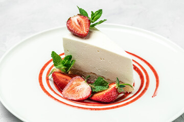delicious homemade strawberry cheesecake with fresh strawberries, jam and mint