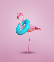 Pink flamingo with inflatable buoy wear rosy glasses - obrazy, fototapety, plakaty