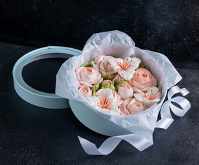 Zephyr bouquet of flowers in a blue box on on a dark background