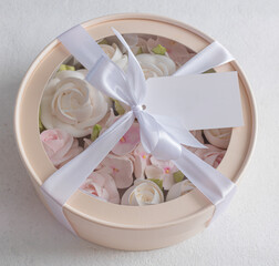 Zephyr bouquet of flowers in a beige box on a gray background