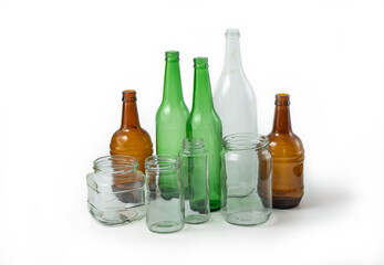 Glass ready to recycle, isolated on white background. A collection of different colored glass bottles and jars. Recycle concept.