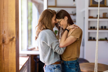 Happy affectionate lesbian couple at home
 - obrazy, fototapety, plakaty