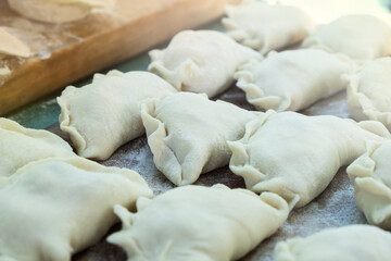 Dumplings on made by hand on a wooden board