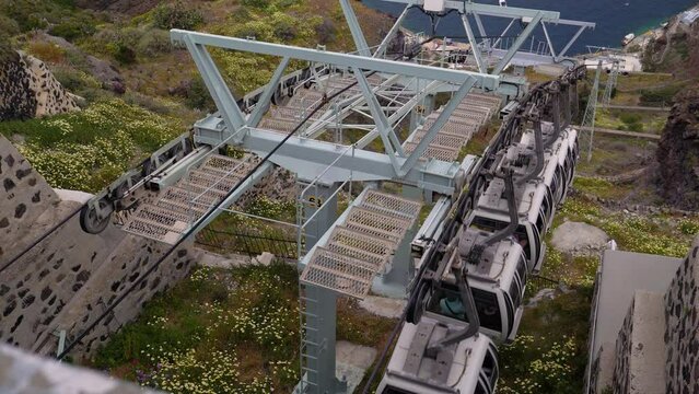 Slow motion footage of the cable car that operates in Fira, Santorini. Old port of Thera on the Greek island of Santorini has a cable car that travels up and down the cliff face.