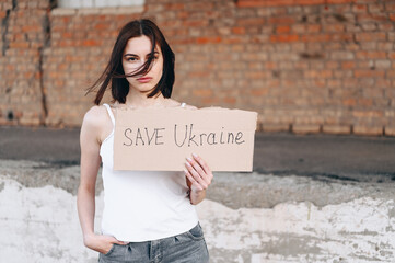 Holds In One Hand A Poster Save Ukraine. War between Russia and Ukraine.