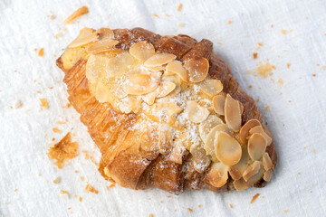 Fresh croissants bread and a cup of coffee on fabric. French breakfast.