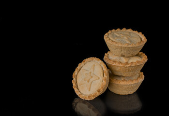 Christmas or Thanksgiving mince pies against a dark background
