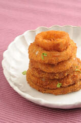 Deep fried onion rings with tomato ketchup, a tea time snack