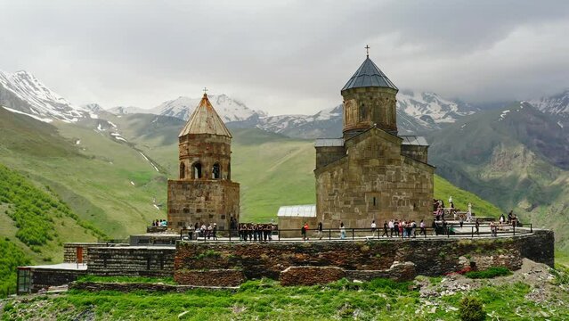 Gergeti Trinity Church Or Tsminda Sameba Holy Trinity Church Near Village Of Gergeti and Kazbek mountain In Georgia. Tourists visit the sights.
