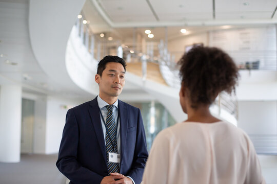Asian businessman meeting with a coworker in the office atrium