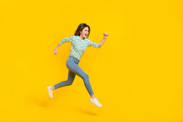 Fototapeta na wymiar Full body profile side photo of charming good mood girl traveling running being sportive active isolated on yellow color background