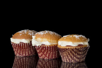 Gluten free muffin with cream on black background