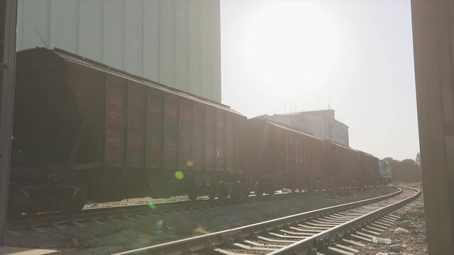 Railway waggons move around the plant. Freight train rides through the factory. Freight train in a factory