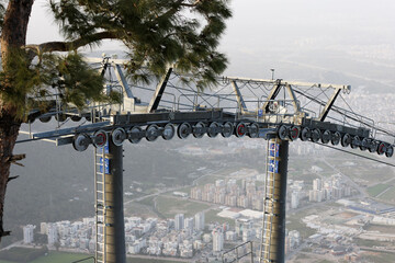Cable car system above city in mountain landscape