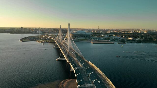Sunset, flight over the cable-stayed bridge of the motorway, over the Neva River in St. Petersburg
