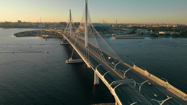 Sunset, flight over the cable-stayed bridge of the motorway, over the Neva River in St. Petersburg