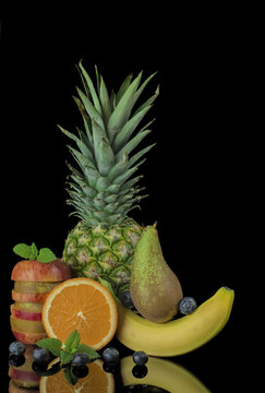 Red apple with pear ,banana,pineapple,black background © Golden Shark