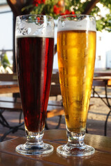 Lager and dark beer on a table, defocuded background