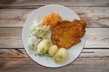 Pork cutlet with potatoes and salad