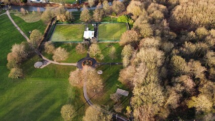 Aerial view looking down onto trees and countryside with houses and buildings in a rural setting. Taken in Lancashire England. 