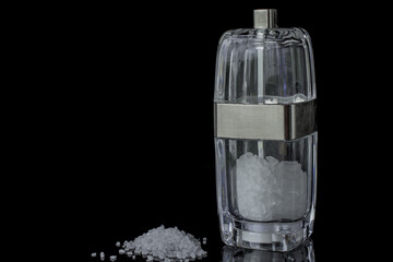 Salt shakers on reflecting background