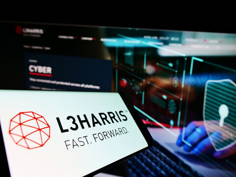 Stuttgart, Germany - 06-18-2022: Smartphone with logo of US aerospace company L3Harris Technologies Inc. on screen in front of website. Focus on center-right of phone display.