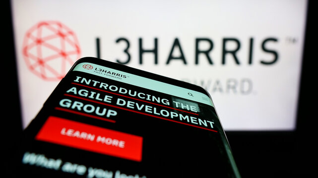 Stuttgart, Germany - 06-18-2022: Mobile phone with website of US aerospace company L3Harris Technologies Inc. on screen in front of logo. Focus on top-left of phone display.