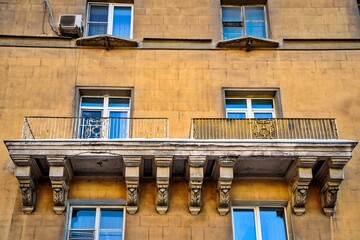 A large balcony in a residential building of old architecture and design.