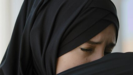 Arabian Islamic Muslim girl in black hijab sneezes allergic 20s Arab Islam woman ill feeling unwell bad suffering sneezing elbow arm blowing running nose sick ethnic lady got flu has allergy symptoms