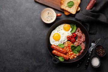 English breakfast with fried eggs, beans, bacon and sausages