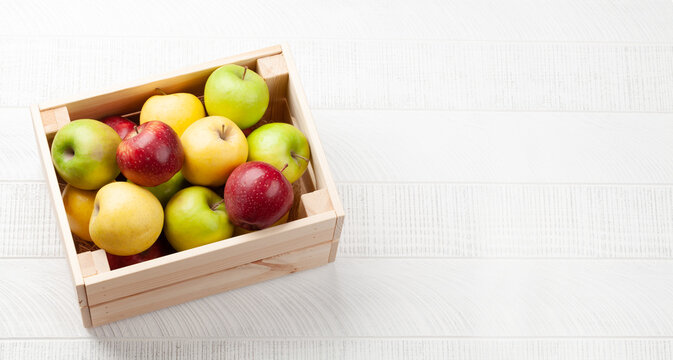 Colorful ripe apple fruits in box