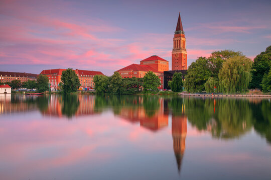 Kiel, Germany. Cityscape image of downtown Kiel, Germany with Town Hall, Opera House and reflection of the skyline in Small Kiel at sunset.