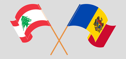 Crossed and waving flags of the Lebanon and Moldova
