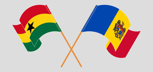 Crossed and waving flags of Ghana and Moldova