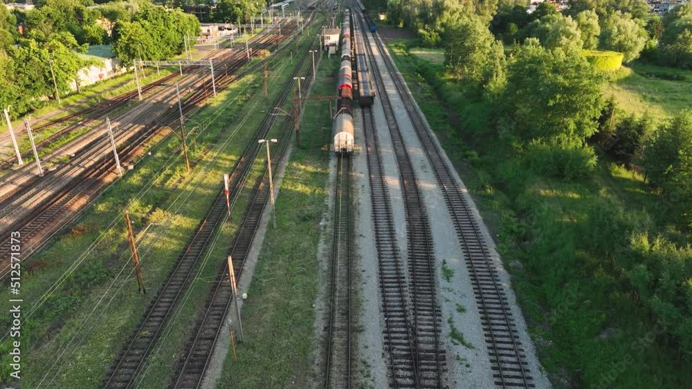Poster the view from the drone on the railroad tracks against the background of the setting sun. concept of
