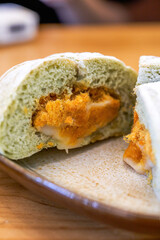 A piece of sweet and tempting matcha bread with meat floss and salted egg yolk