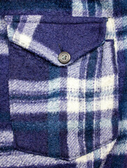 Fototapeta na wymiar Buttons on an old vintage woven pocket. Vintage blue jacket pocket.Vintage sweatshirt design.