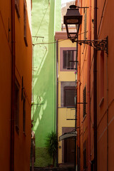 Vertical view of end of colorful houses alley street in the traditional village of Bosa, Sardinia, Italy