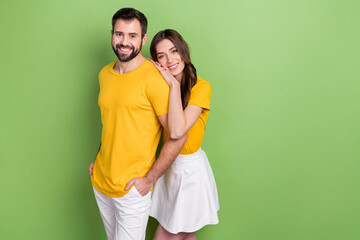 Photo of two idyllic peaceful partners embrace care support empty space isolated on green color background