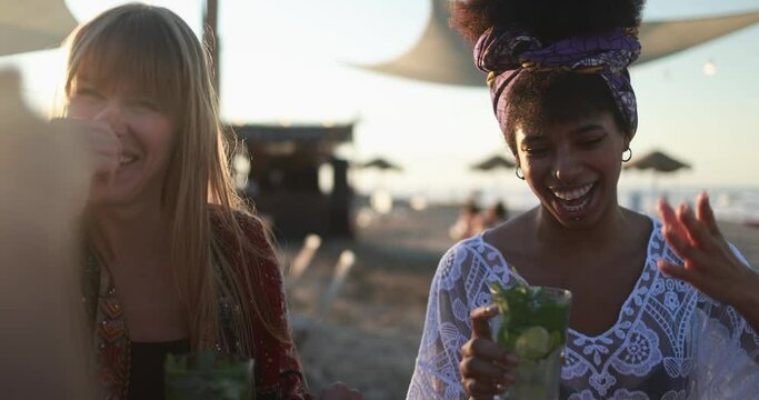 Multiracial happy friends drinking mojitos at beach party
