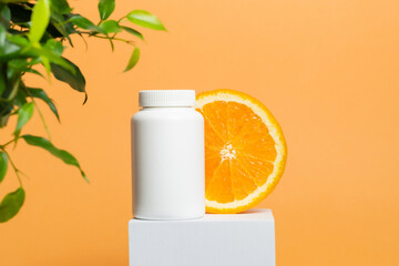 Medicine bottle of vitamins or pills with sliced orange, vitamin C, multivitamin natural supplement, bottle mockup