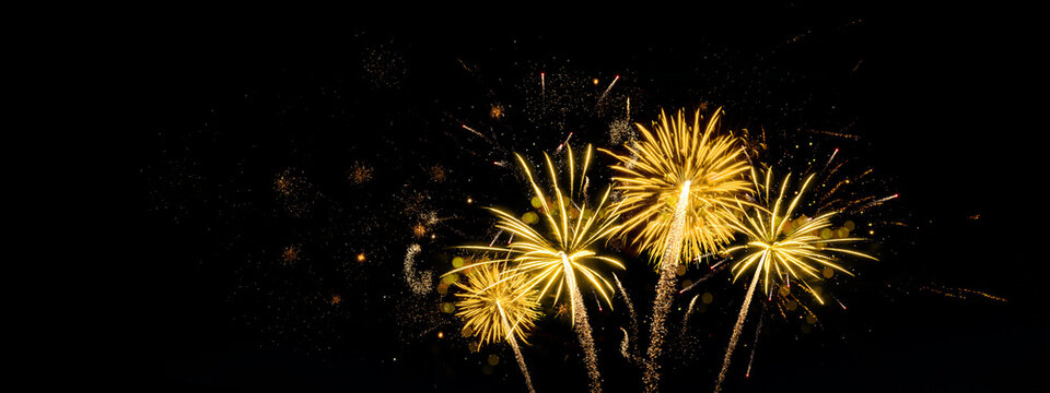 HAPPY NEW YEAR - Celebration New Year's Eve, Silvester 2023 holiday background panorama greeting card - Goldeen firework fireworks pyrotechnics on dark night sky..