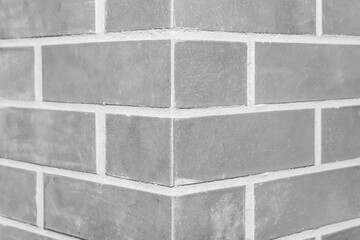 Corner brick column fragment close-up architecture of the joint grey wall of the interior texture...