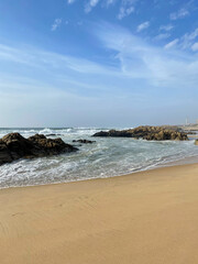 Stunning view of yellow sandy beach with rocks and Atlantic ocean in Matosinhos Beach in Portugal